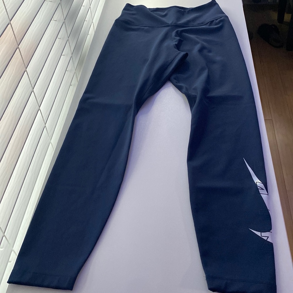 Navy blue Nike leggings with Nike sign on bottom of leg